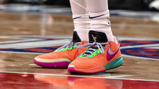View of orange and green Nike LeBron shoes.